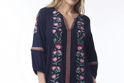 Navy blue dress with floral embroidery on a white background